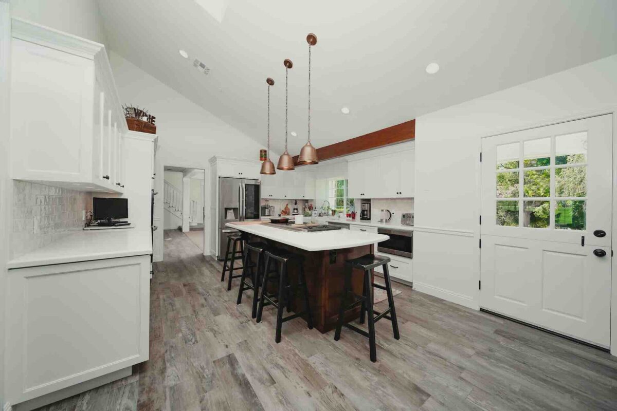 Modern white kitchen with island and pendant lights